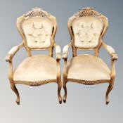 A pair of carved beech framed armchairs in buttoned dralon