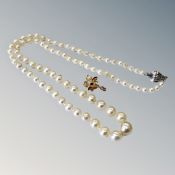 A strap of pearls with silver clasp and a 14ct gold pearl pendant