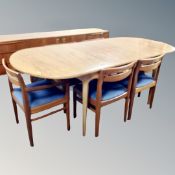 An A H Macintosh teak oval extending dining table with leaf, six chairs.