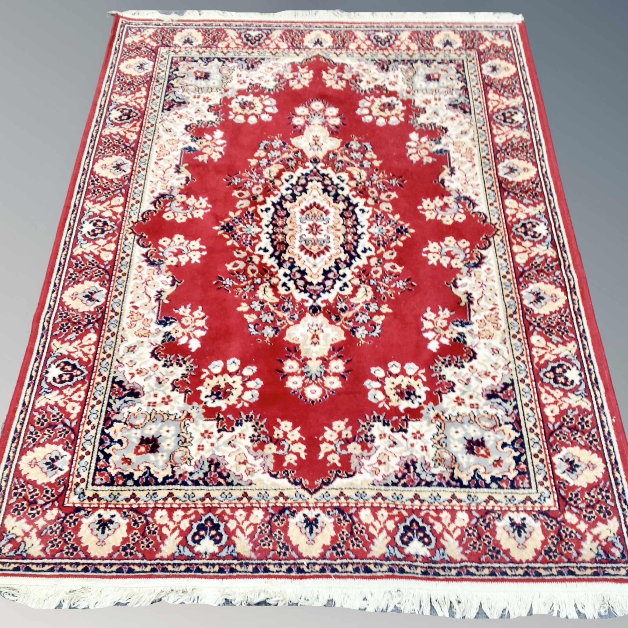 A machine made Persian rug 198 cm x 140 cm