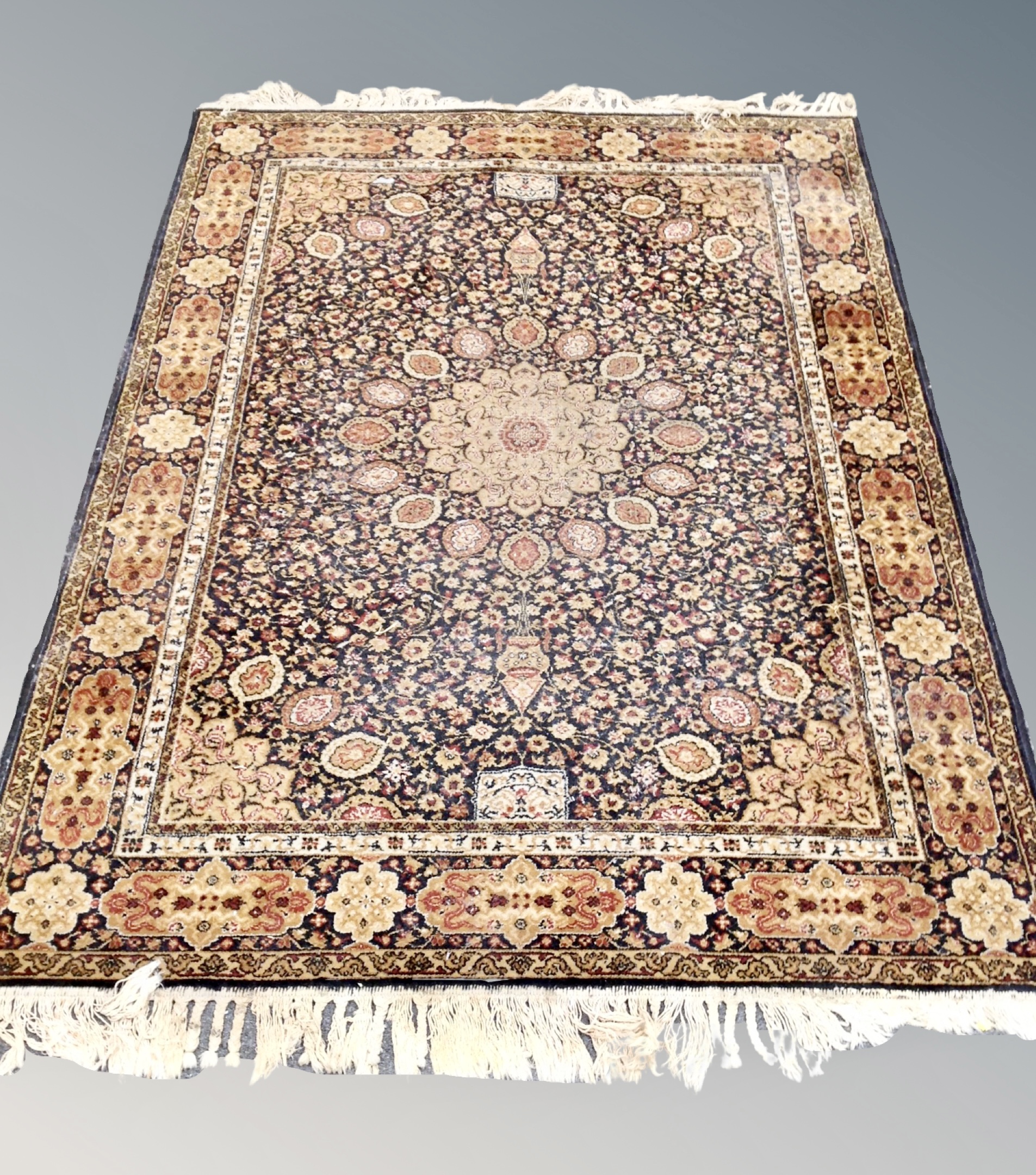 A machine made Tabriz design rug 196 cm x 143 cm
