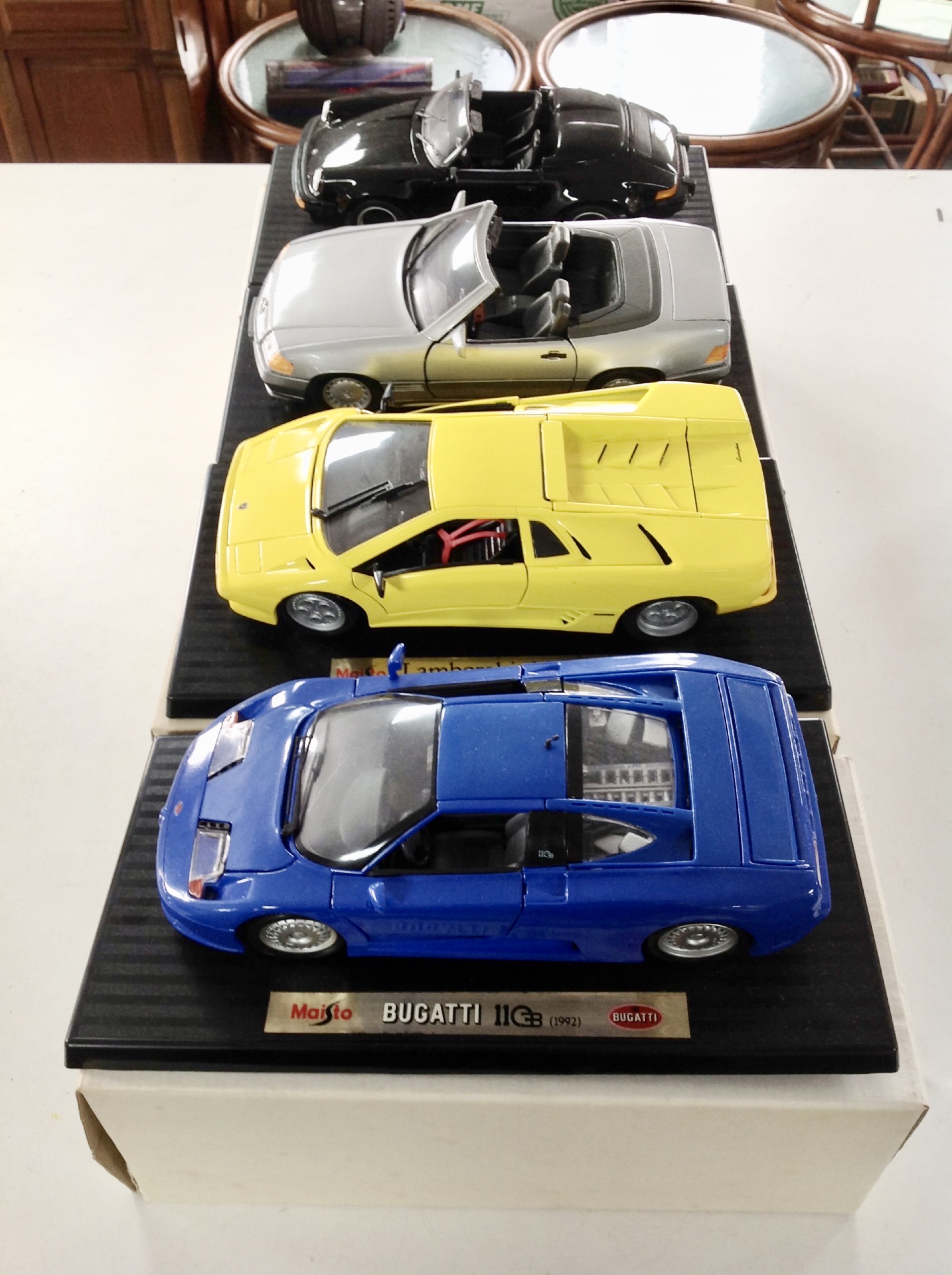 Four Maisto die cast vehicles : Lamborghini Diablo 1990, Porsche 911 Speedster 1989, Bugatti 1992,