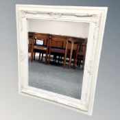 A classical framed white bevelled mirror