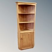 An Ercol elm and beech open corner unit