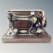 A vintage Singer sewing machine in case with key