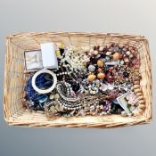 A wicker basket containing a quantity of good quality costume jewellery