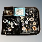 A tray of costume jewellery, vintage and later dress brooches,