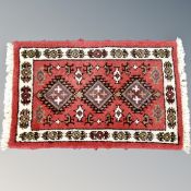 A small Eastern hearth rug 62 cm x 40 cm