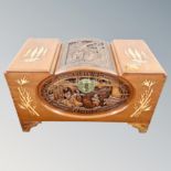 An ornate carved Chinese camphor wood box with brass lock