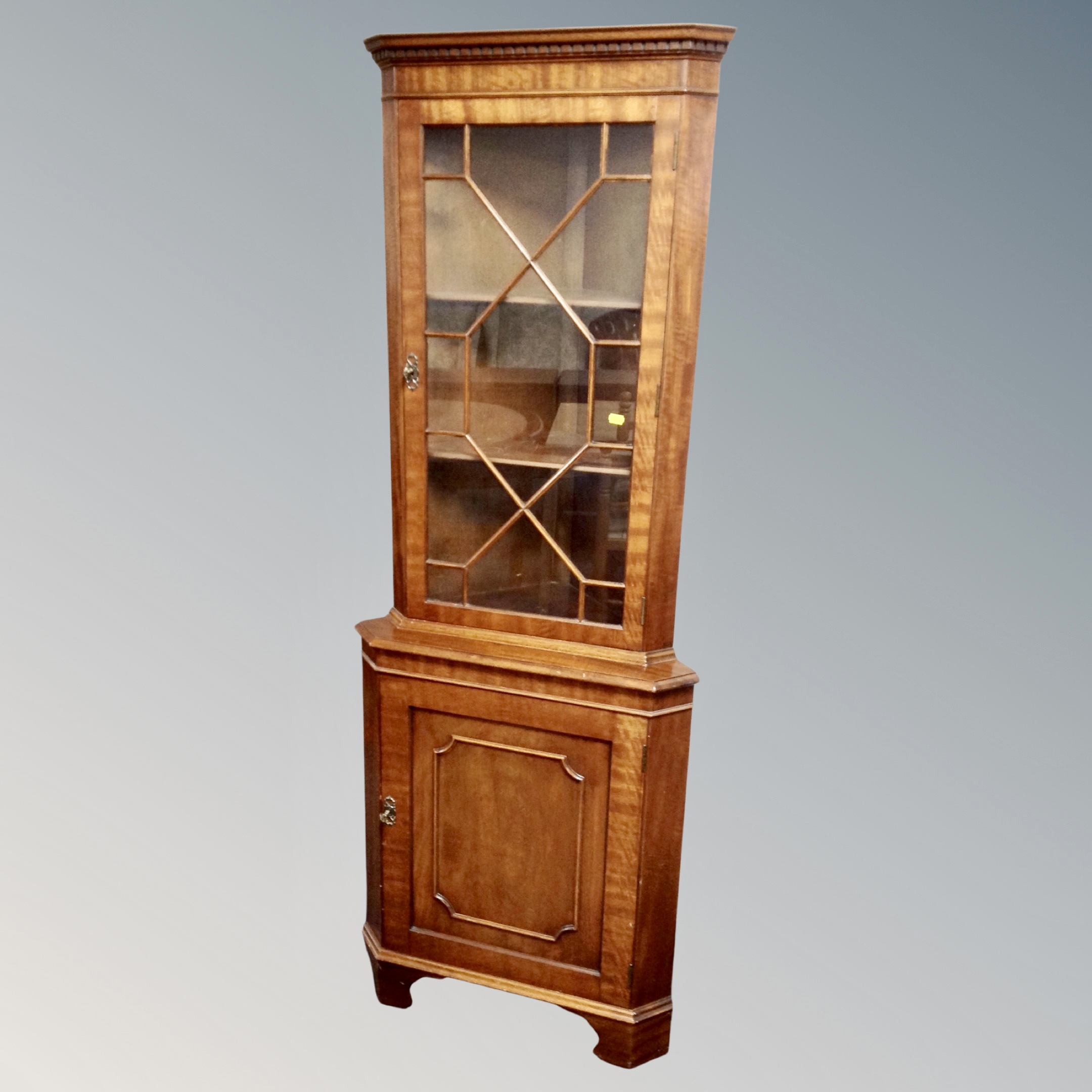 An astragal glazed door corner cabinet with cupboard below