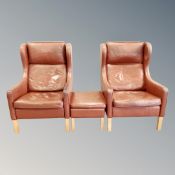 A pair 20th century Danish tan leather wing backed armchairs with matching footstool