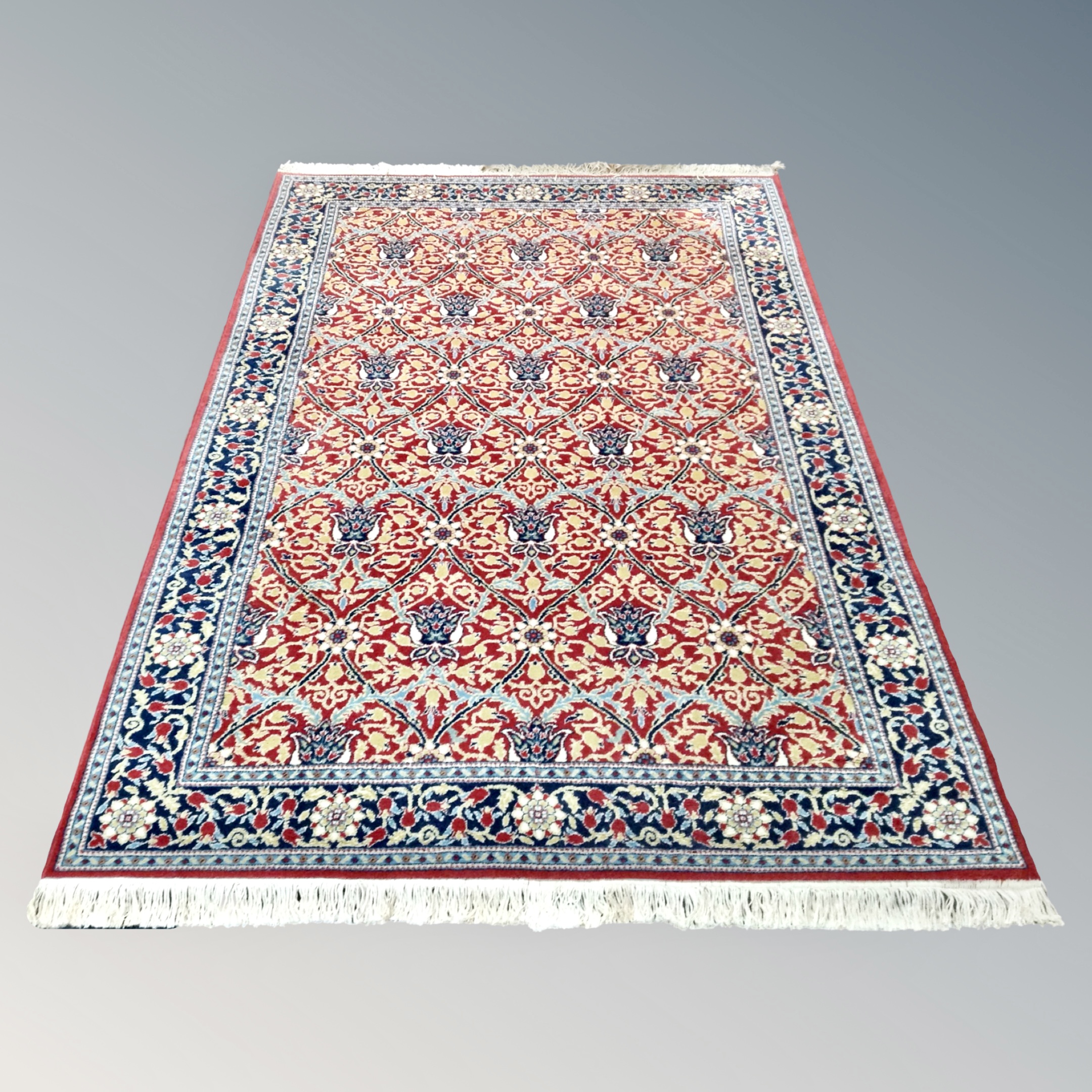 A machine made Keshan design rug on red ground 150 cm x 230 cm