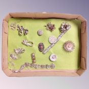 A collection of white metal and silver filigree brooches,