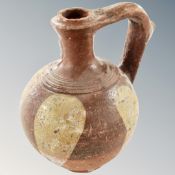 An antique glazed pottery wine jug (af). Height 18cm.