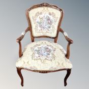 A carved framed open salon chair in tapestry fabric