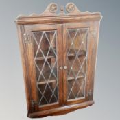 An Old Charm oak wall cabinet together with similar corner cabinet