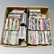 Two boxes containing approximately 100 dvds