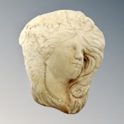 A concrete garden wall pocket - female head