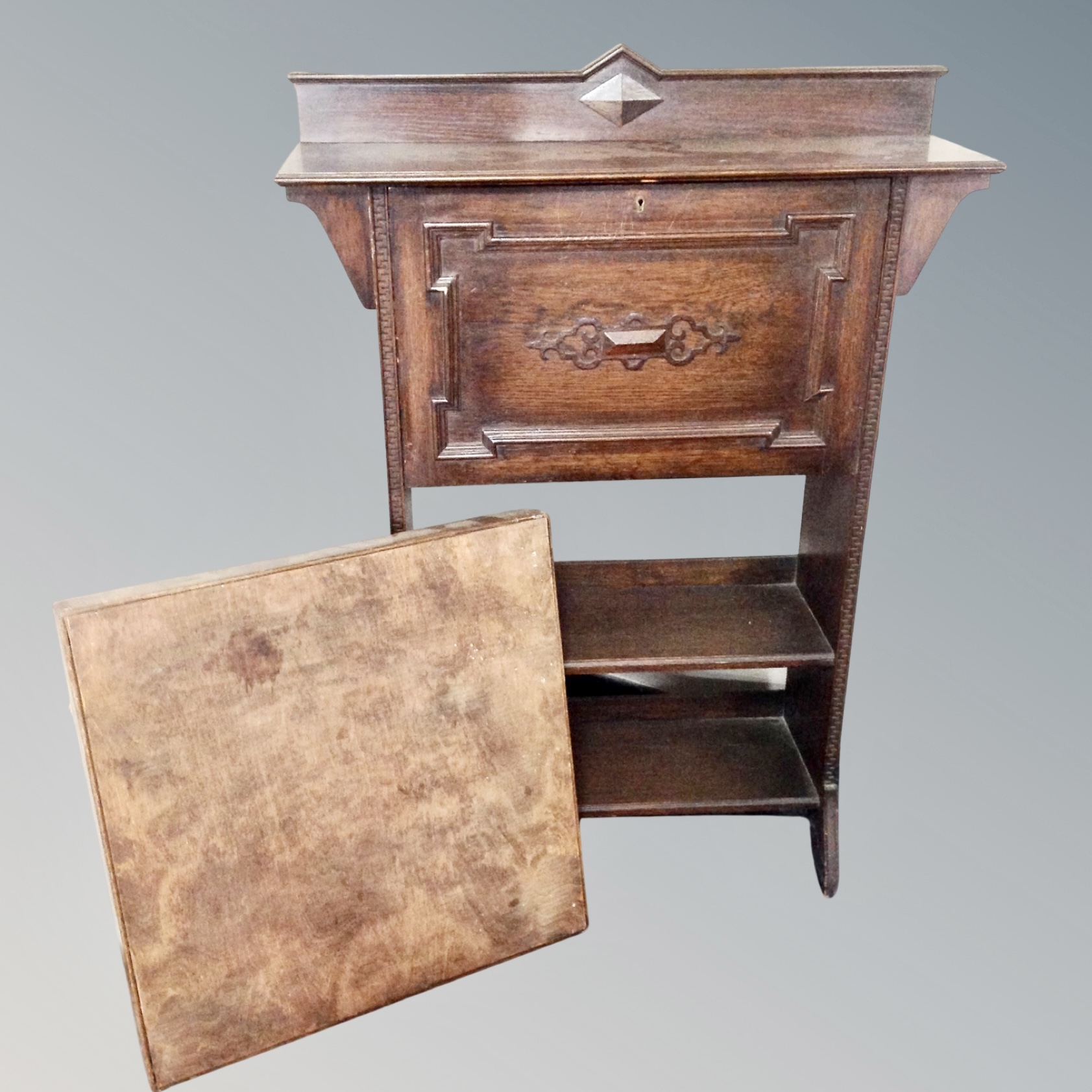 An Arts and Crafts oak bureau together with a folding card table