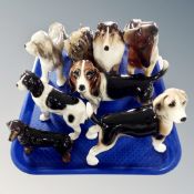 A tray of seven Coopercraft dog figures and a figure of a basset hound