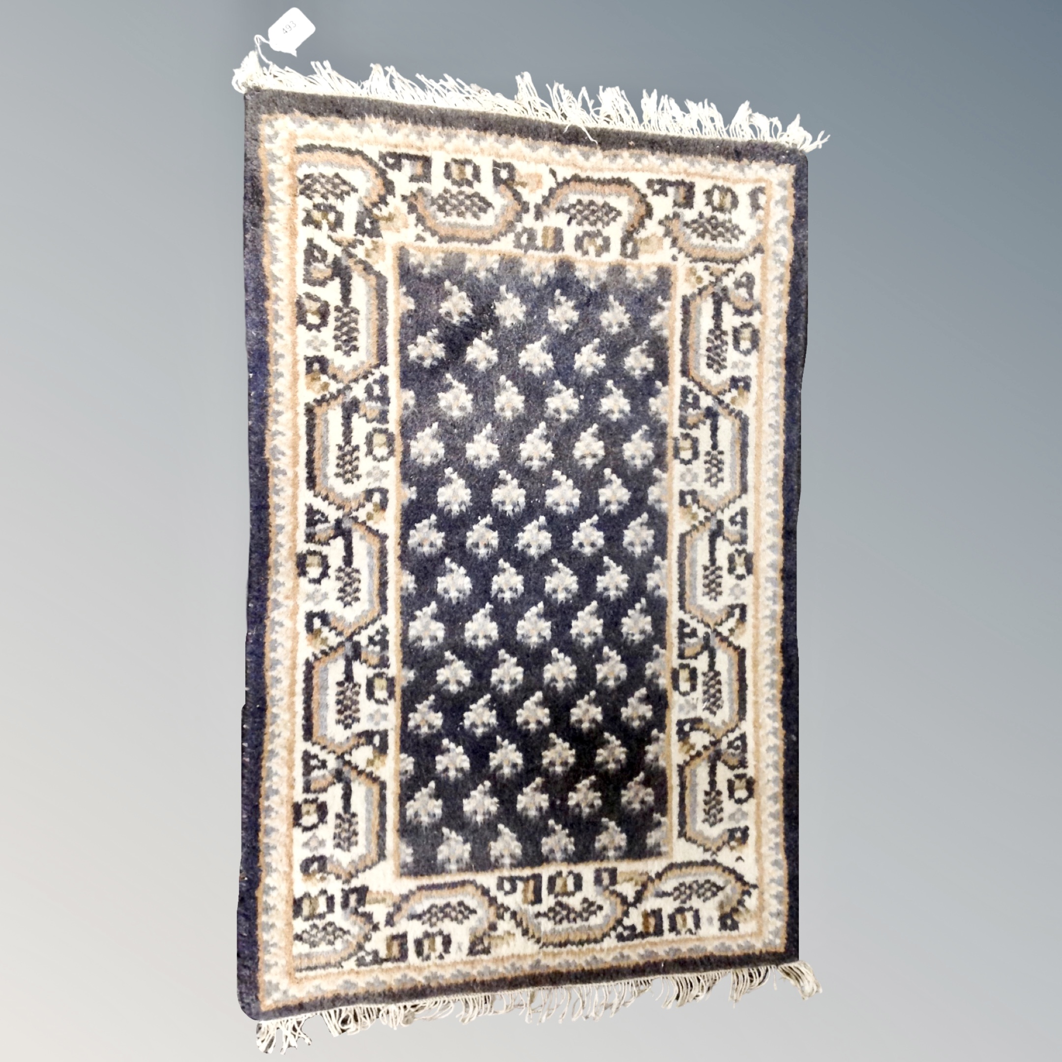 A small Eastern hearth rug 90 cm x 61 cm