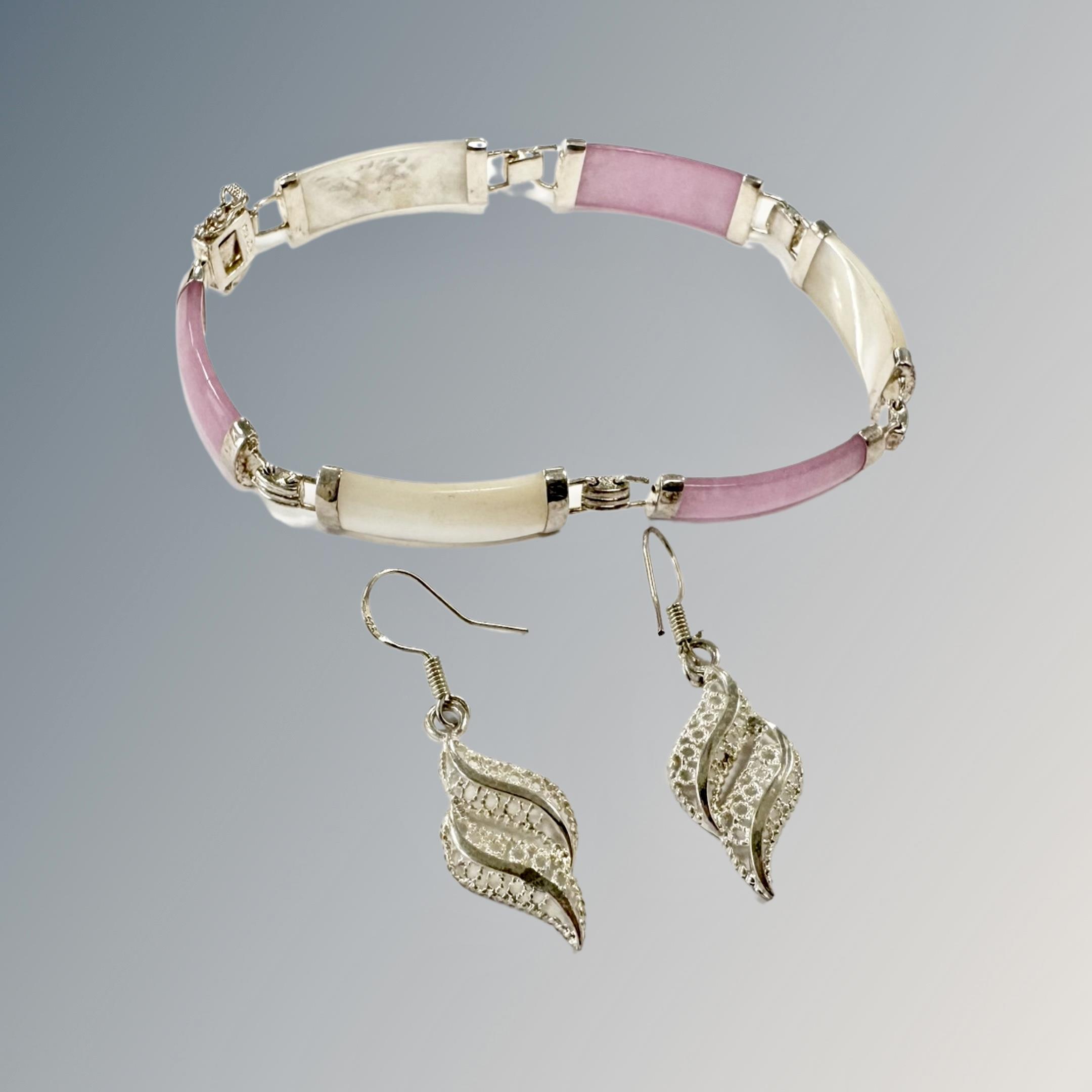 A silver stone set bracelet and a pair of earrings