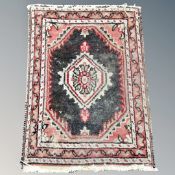 An Eastern hearth rug 62 cm x 47 cm