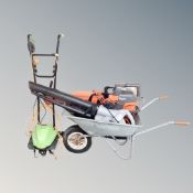 A wheel barrow together with a flymo garden vacuum,