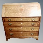 A George III inlaid oak fall front bureau fitted with drawers