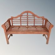 A Lutyens-style wooden slatted garden bench