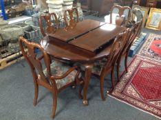 A contemporary Queen Anne style extending dining table with two leaves,