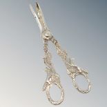 A very ornate pair of silver grape scissors depicting foxes.