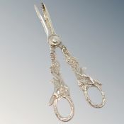 A very ornate pair of silver grape scissors depicting foxes.