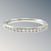 A platinum diamond half eternity ring, the stated diamond weight 0.