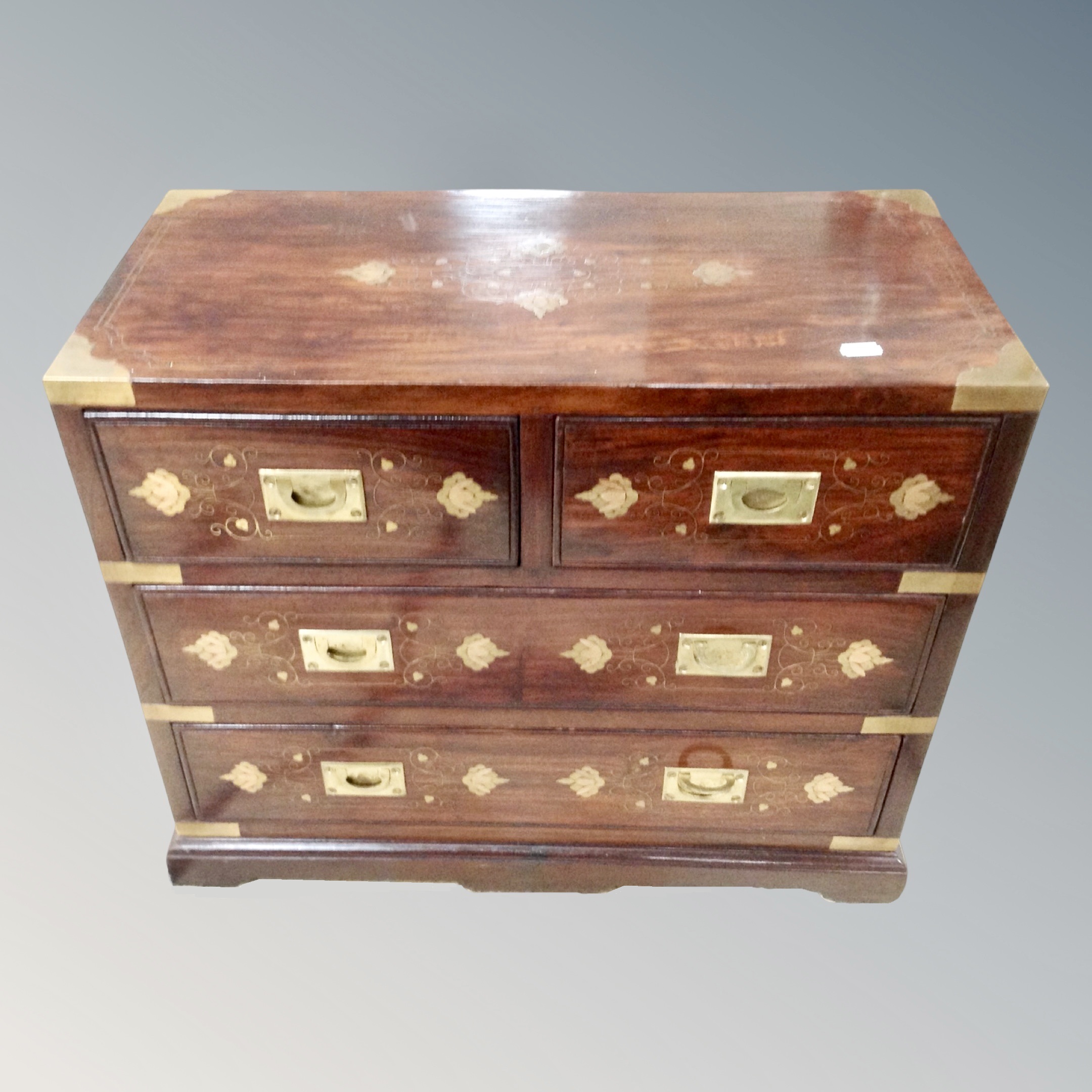 A Chinese hardwood brass inlaid four drawer campaign style chest,