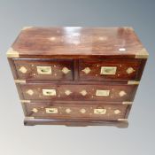 A Chinese hardwood brass inlaid four drawer campaign style chest,