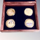 A set of four 24ct gold plated End of WWII commemorative coins in case