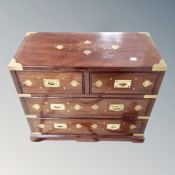 A Chinese hardwood brass inlaid four drawer campaign style chest,