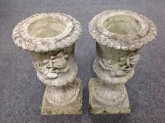 A pair of concrete rose pattern urn planters