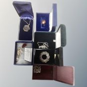 A collection of six assorted silver pendants on chains, brooches, silver gilt badge,