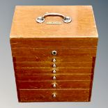 A mid 20th century portable dentist's chest, fitted with six drawers and rising top section,