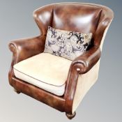 A brown leather and fabric armchair with cushion