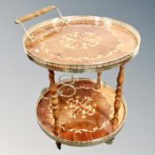 An Italian style circular two tier drinks trolley with brass gallery
