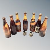 Seven miniature beer bottles, sealed, Harp lager and Guinness,
