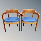 A pair of 20th century Danish Munch Mobler teak elbow chairs