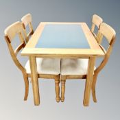 A contemporary oak kitchen table with painted inset panel together with four chairs