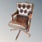 A good quality Victorian style captain's desk chair in brown buttoned leather