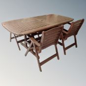 A wooden slatted garden table together with four folding chairs and further pair of high backed