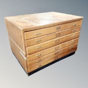 A mid century six drawer plan chest, 88cm high by 128cm wide by 96cm deep.