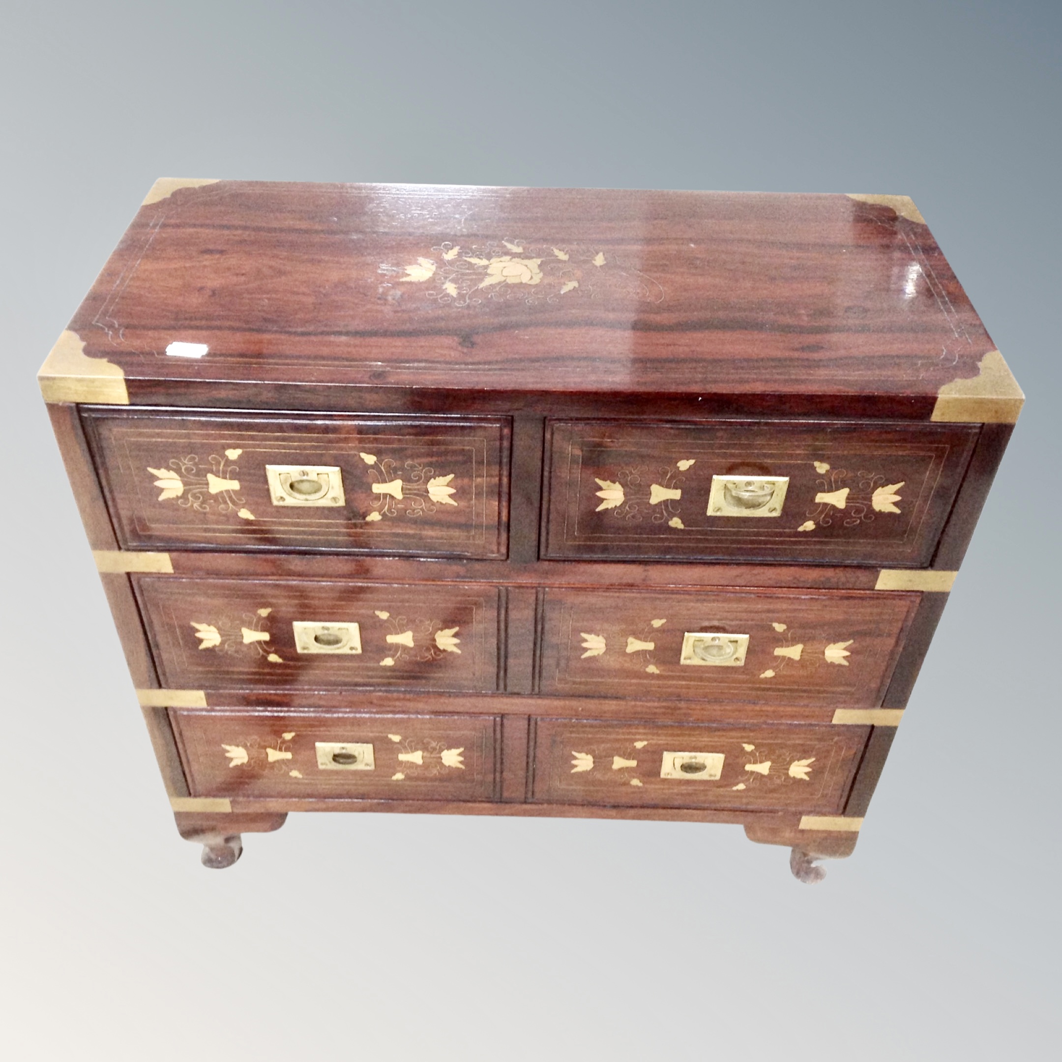 A Chinese hardwood brass inlaid four drawer campaign style chest,